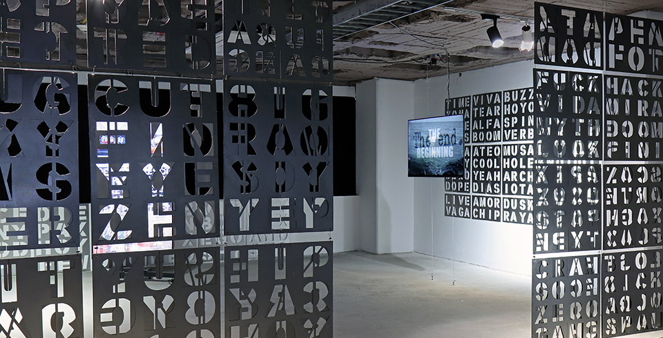 The Ends of Words, 2023 / Exhibition view, Voltaje, 10th edition, Bogotá, Colombia / Cut letter plates & algorithmically composed video installation on 3 screens