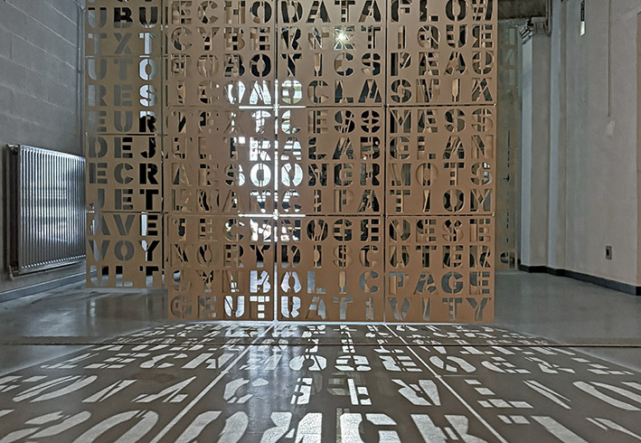 The End of Writing, 2026 / Exhibition view, L'Ososphere, Strasbourg, France, 2026 / Cut letter plates & algorithmically composed video installation on 3 screens / Video software : Claude Micheli